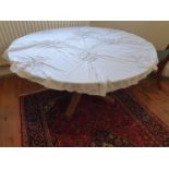 A reproduction circular Table on tripod support to seat eight people.