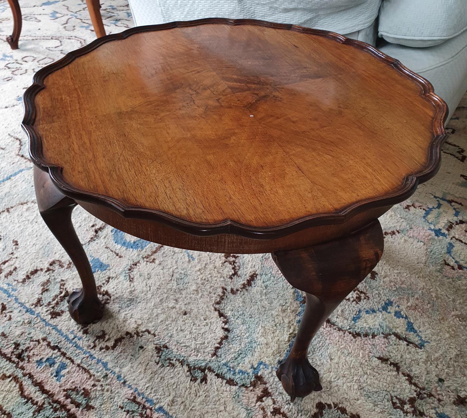 An Edwardian Walnut low Side Table with scalloped edge on ball and claw feet. Diam.60 x H39cm