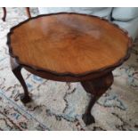 An Edwardian Walnut low Side Table with scalloped edge on ball and claw feet. Diam.60 x H39cm