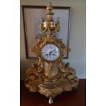 A fantastic 19th Century Ormolu Mantle Clock with a profusely molded outline.