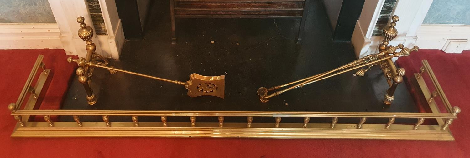 A 19th Century Brass Fender with turned finial supports. A pair of Fire Dogs along with a