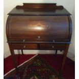 An Edwardian Mahogany Inlaid Cylinder Desk with pull out front, pigeon holes and on tapered