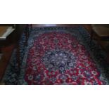 A red and blue ground fine woven Najaf Carpet from Isfahan region of Iran with central Lazanja