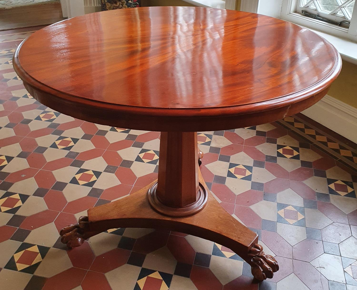 A Victorian Mahogany circular Centre Table with platform base and hairy paw feet. D90 x H72cm