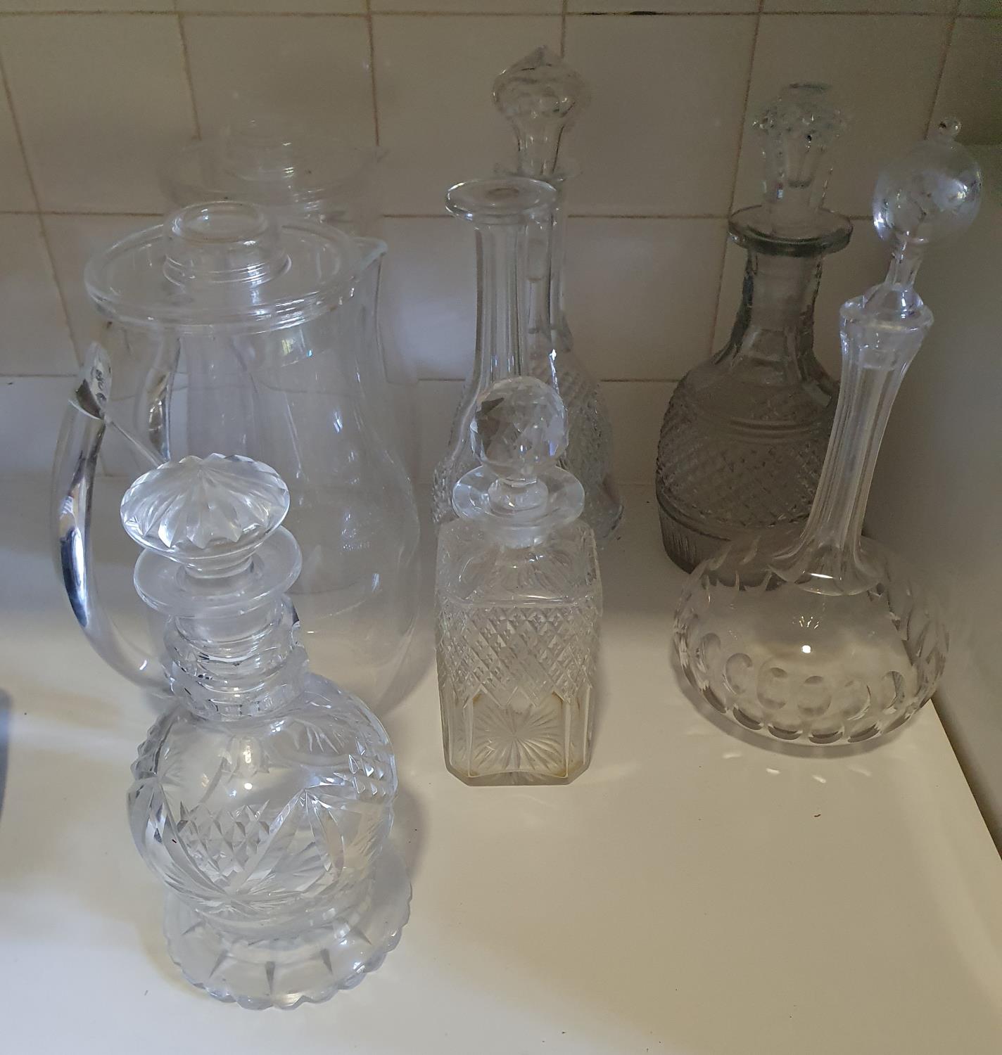 A good quantity of Crystal Decanters along with two Water Jugs.