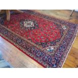 A red ground Persian Kashan Carpet with unique traditional Kashan floral design and multi borders.