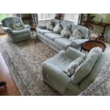 A good green Upholstered three piece Suite. Couch W220 approx, a chair 97cm approx.