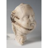 Head of cherub. Italy, 17th century. Marble. Measurements: 19 x 11 x 11 cm. Head of cherub from