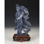 Figure of fairy with flowers and bird. China, XX century. Lapis lazuli hand carved on wooden base.