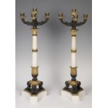 Pair of candlesticks; Restoration period, circa 1820. Bronze, fine gold and marble. Measures: 60 x