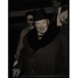 PRESS PHOTOGRAPH OF SIR WINSTON CHURCHILL COMES HOME WITH A HOLIDAY SMILE