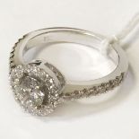18 CT. WHITE GOLD DIAMOND SOLITAIRE RING WITH HALO CLUSTER TOTAL DIAMOND WEIGHT IS APPROX. 0.85