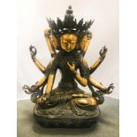 A MONUMENTAL CHINESE PARTIAL GILT METAL FIGURE DEPICTING A THREE-FACED, EIGHT-ARMED BODHISATTVA