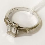 18 CT. GOLD EMERALD CUT RING CENTRE STONE (1.18 CARAT) WITH DIAMONDS TO THE SHOULDER - SIZE J