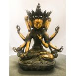 A MONUMENTAL CHINESE PARTIAL GILT METAL FIGURE DEPICTING A THREE-FACED EIGHT ARMED BODHISATTVA -