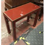 RED HALL TABLE WITH BRASS TRIM