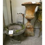 A cast iron urn shape planter, raised on a square base, 88 cm, together with a reconstituted stone