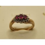 A 9ct gold ruby and diamond triple cluster ring, 3.5 gms, size L 1/2.