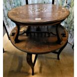 A mahogany inlaid two tier occasional table with curved tapering legs, 70 cm diameter.