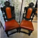 A pair of carved oak dining chairs.