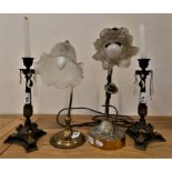 A pair of metal and gilt candlesticks with glass drops, a tubular brass desk lamp with glass shade
