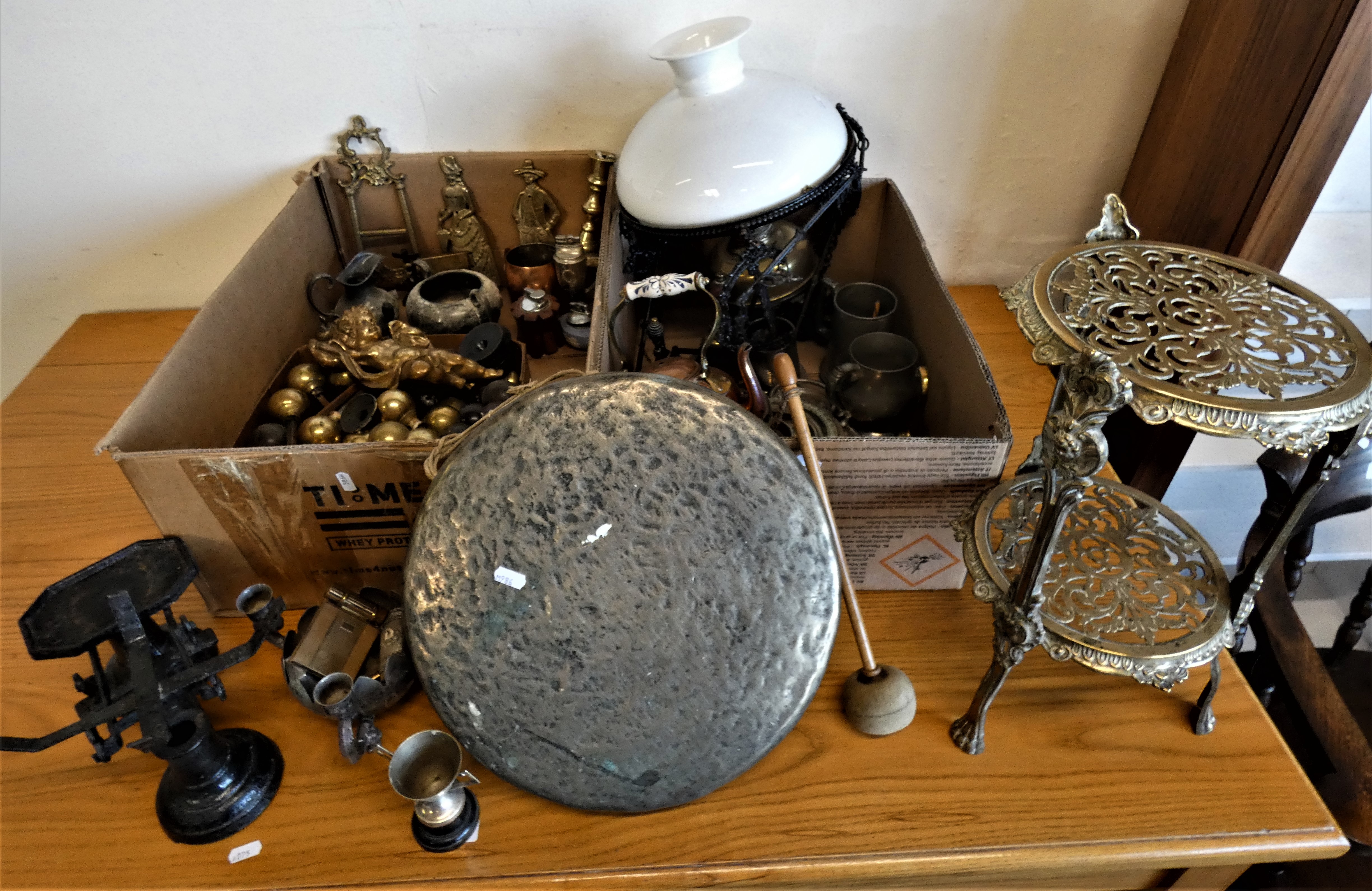 A brass two tier table, copper kettle, oil lamp, scales, and a quantity of brass round door