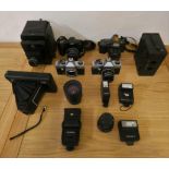 A collection of camera's, Victory Reflex, Praktica and a Bell & Howell cine camera, together with