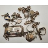 A silver charm bracelet and other silver ware.