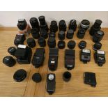A collection of camera lens and flashes, to include Sigma, Nikon and Canon.