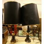 A pair of black and brass table lamps with shades.