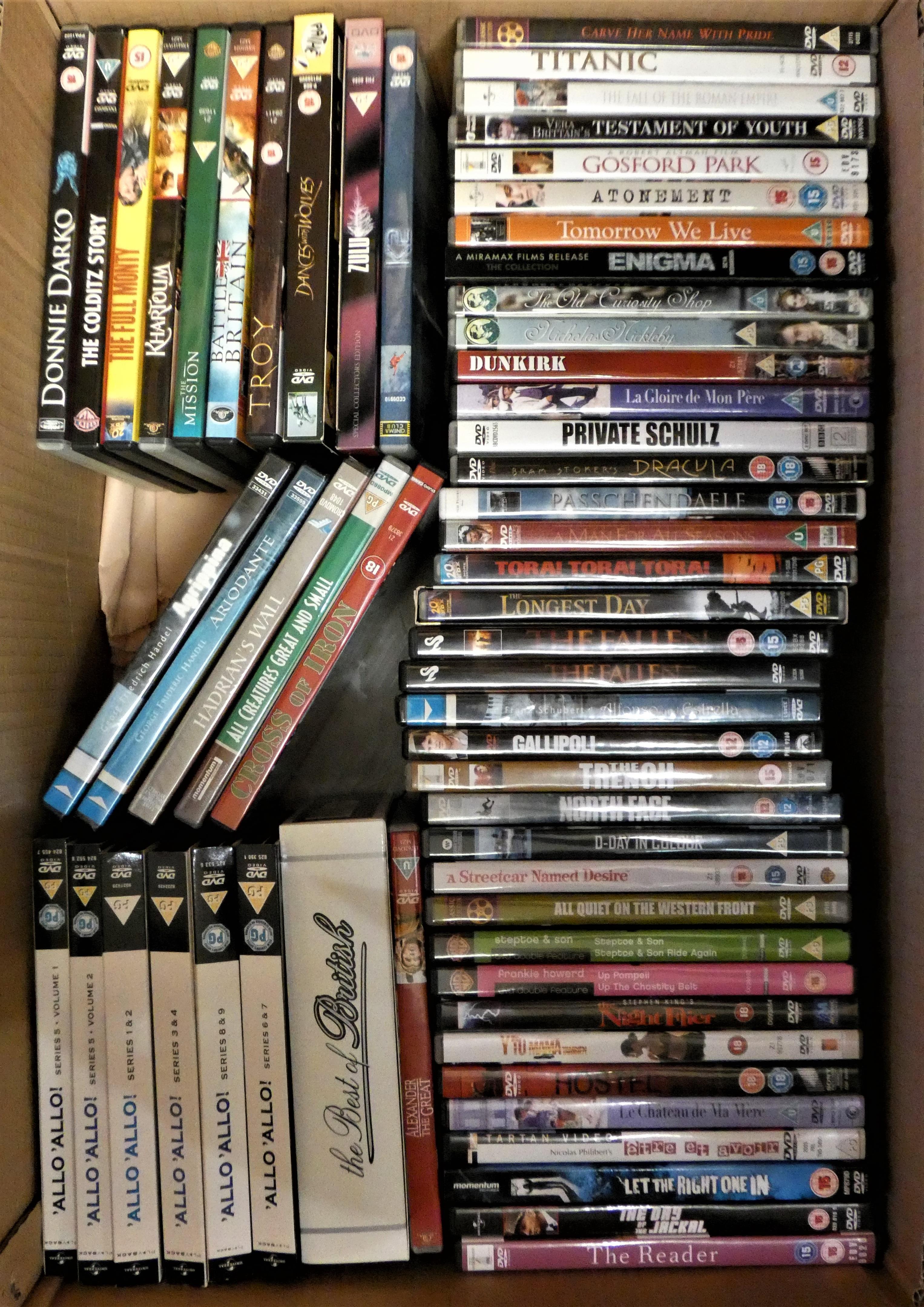 A large collection of DVDs and VHS tapes (2).