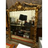 A Victorian/Edwardian wood and plaster gilt over mantle mirror with floral spay supports, 177 x