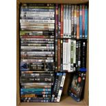 A large collection of DVDs and VHS tapes, approximately 100 (2).