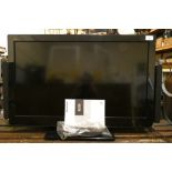 A Panasonic TX-L32E30B television with external speaker system, hand set.
