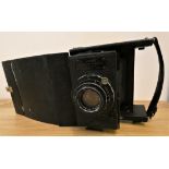 An Ensign folding reflex camera, model D, various plates and case.