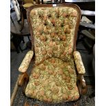 A mahogany framed button back armchair in floral fabric.