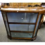 A glazed mahogany 3 height display cabinet with canted top over 3 sets of sliding glass doors 118