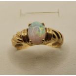 A gold and opal set ring, stamped 750, size N 1/2, size 3 gms.