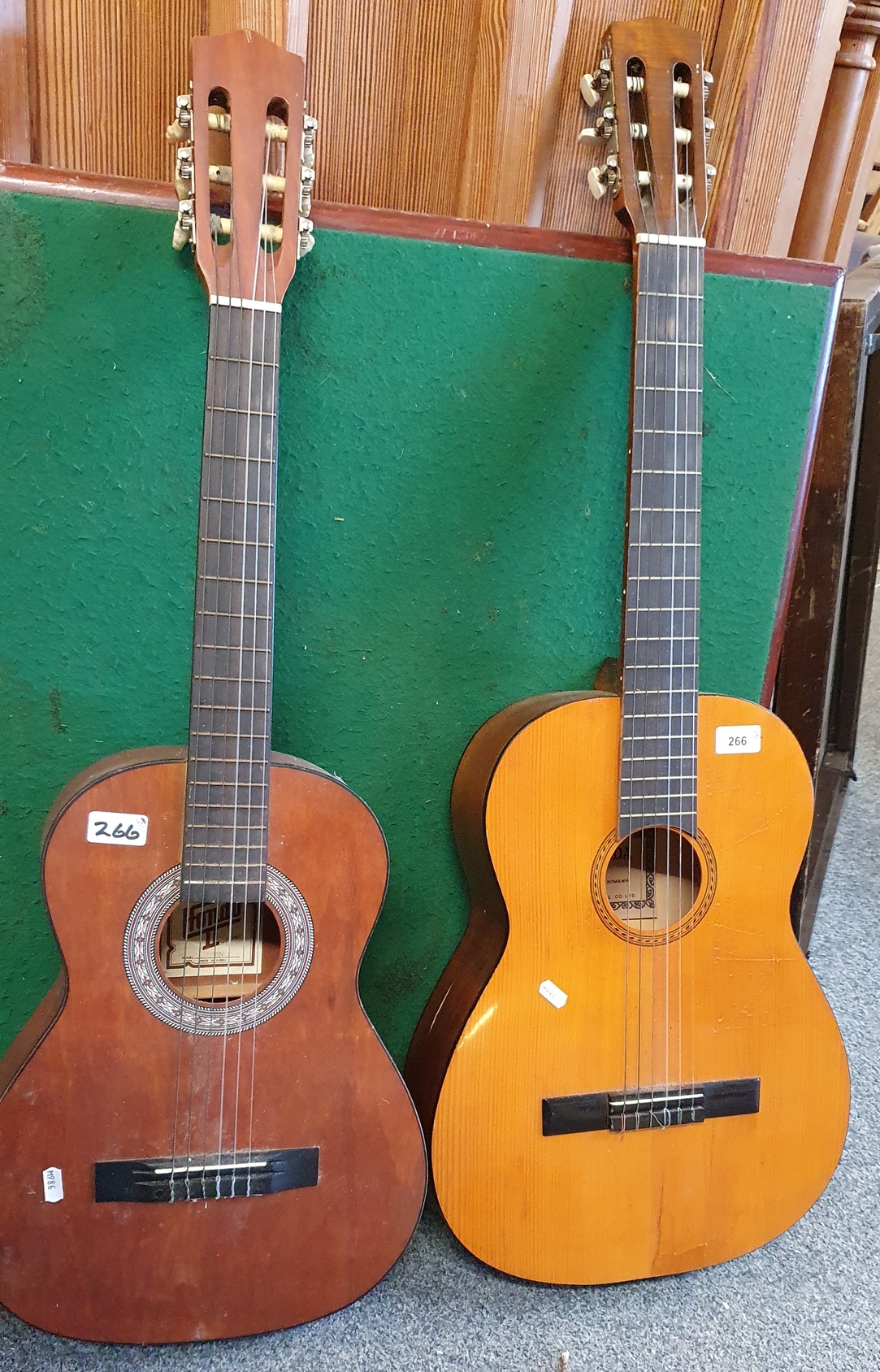 An Hokada acoustic guitar, and a Hondo acoustic guitar. (2)