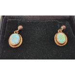 A pair of 9ct gold and opal ear rings.