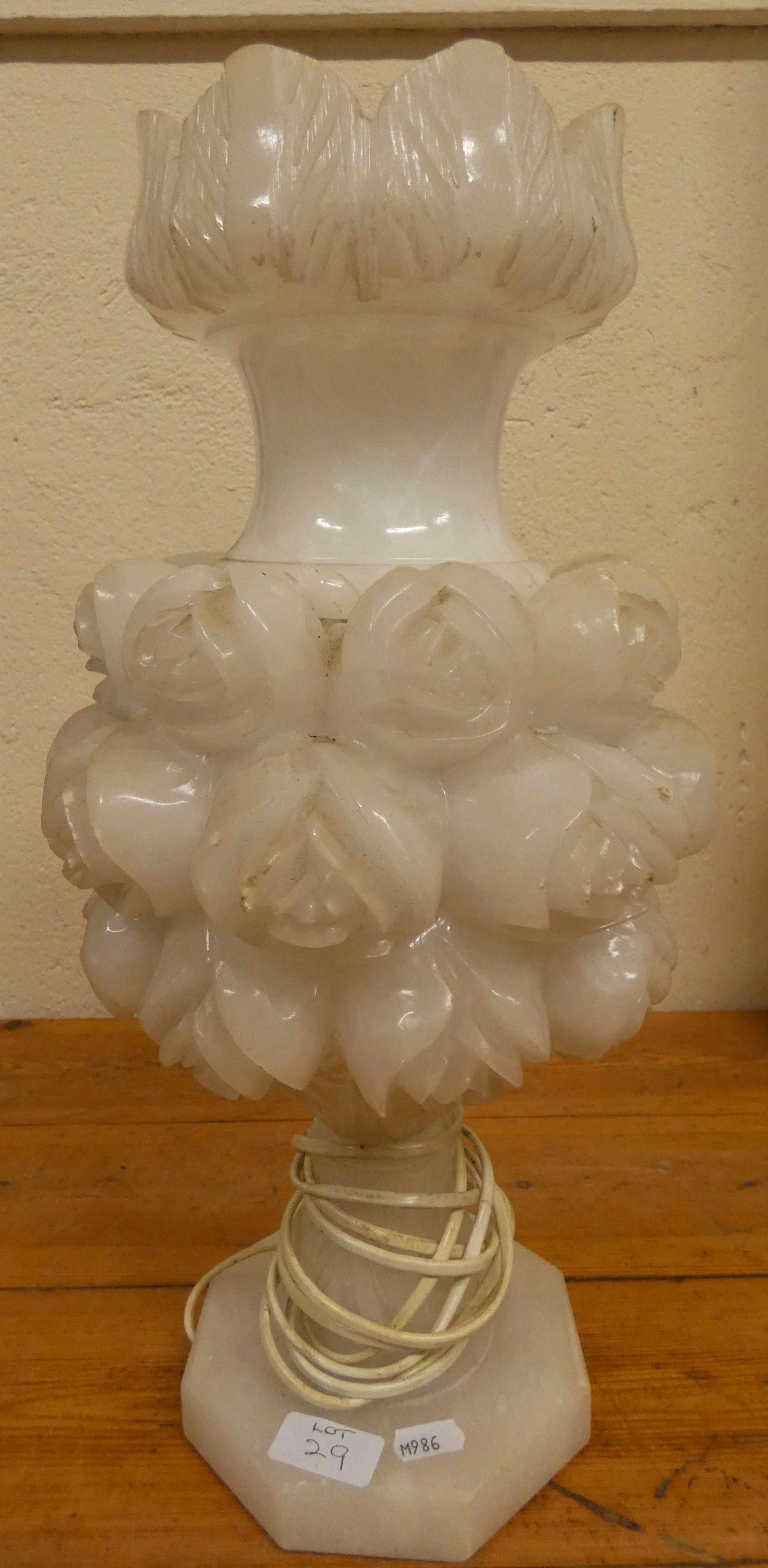A facetted glass and brass table lamp, 55 cm, a carved quartz floral lamp, 48 cm and two other lamps