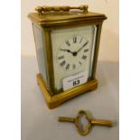A French brass cased manual wind carriage clock with white enamelled dial and Roman numerals.