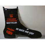 A black painted sign in the shape of a boot, with Cherry Blossom logo.