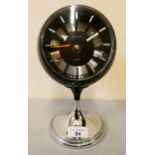A 1970s retro clock by Acctim, battery operated, black plastic case, sphere on chromed base. 23 cm