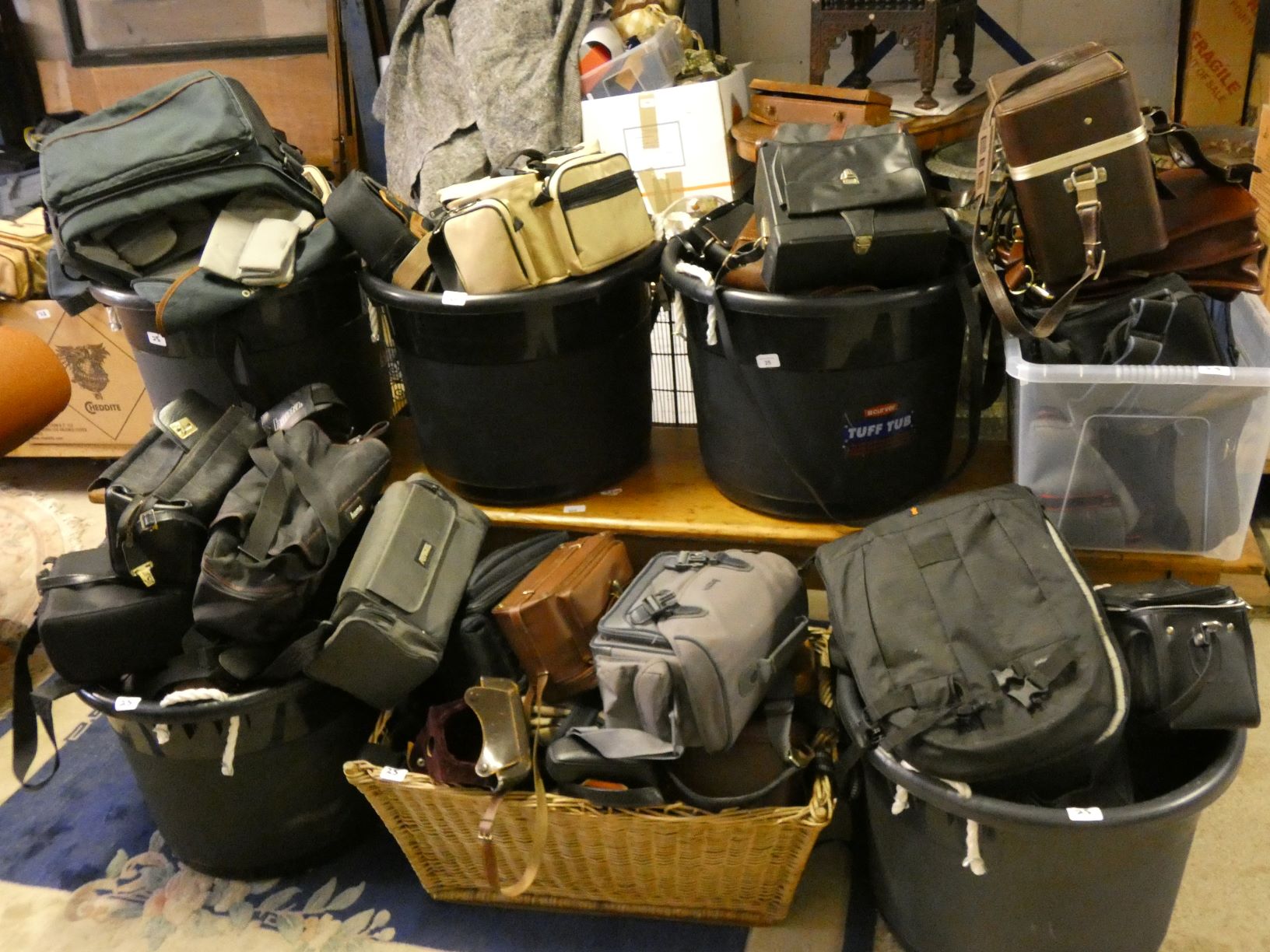 A very large collection of empty camera bags