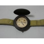 A military style wrist worn compass with hunter cover, unmarked.