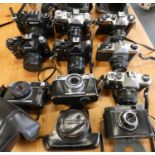 A collection of cameras, to include Zenith 122, E, Em, 12 XP, Pentax K1000, Canon Canonet Junior.