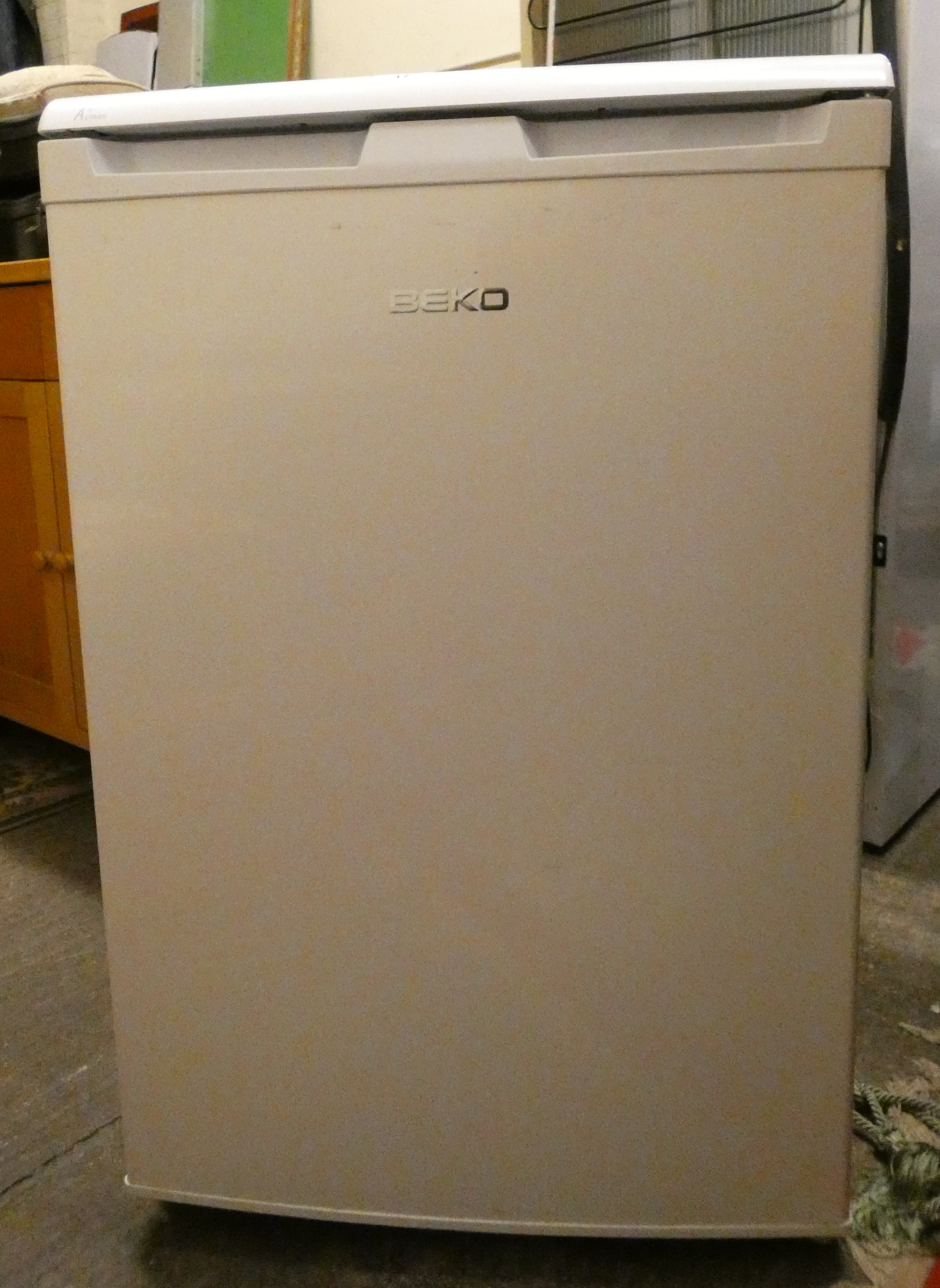 A Beko free standing larder fridge 84 cm tall 54 cm wide.