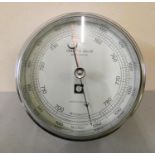 A chromed cased bulk head fitting barometer from Lilley & Gillie, North Shields. 15cm diameter.