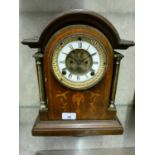An inlaid oak cased mantle clock with arched top and brass columns. 32cm tall. (AF)
